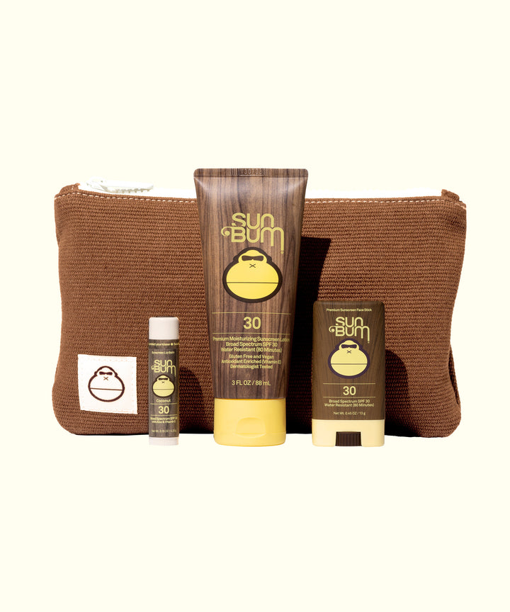 Road Tripper travel kit with SPF 30 sunscreen, lip balm and face stick in brown corduroy bag by Sun Bum
