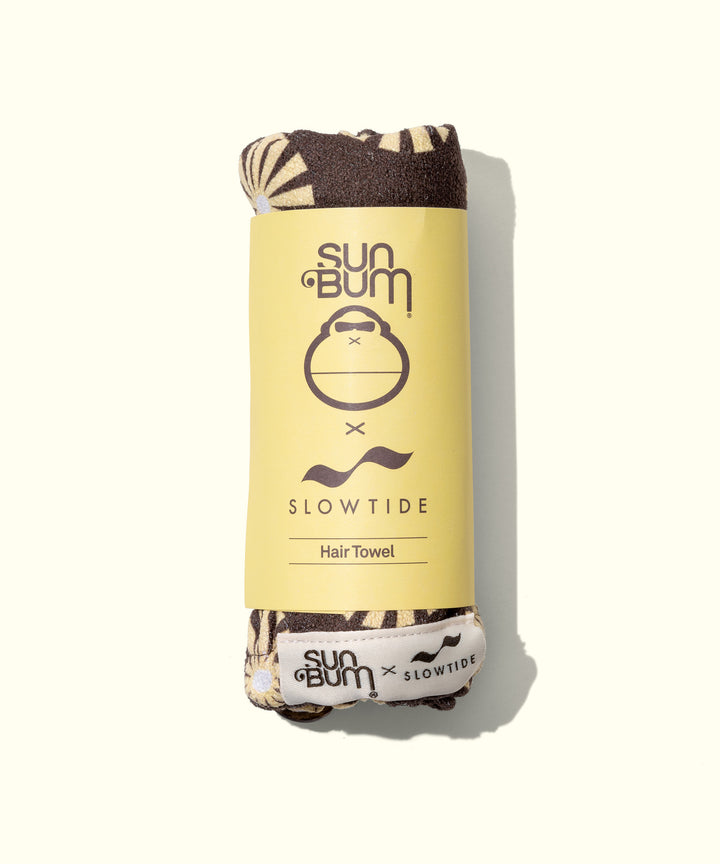 Air Dry Cream & Hair Towel Kit featuring a rolled brown and cream patterned microfiber hair towel with Sun Bum x Slowtide collaboration branding on yellow packaging, designed for gentle hair drying and styling - by Sun Bum